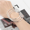 Three Silver Plated Bracelets Are Worn at The Same Time